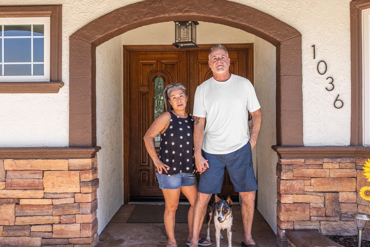 Bill and Claudia Pryor standing at Serenity&rsquo;s front door with Tiger, their dog